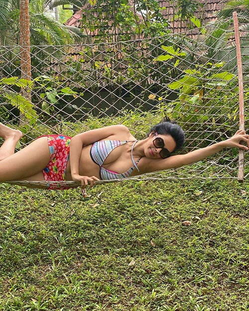 mallika 2 - Mallika Sherawat, 44, sizzles in a bikini - see her flaunt her sexy body on the beach.