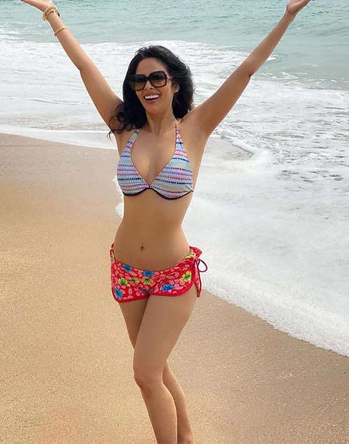 mallika 3 - Mallika Sherawat, 44, sizzles in a bikini - see her flaunt her sexy body on the beach.