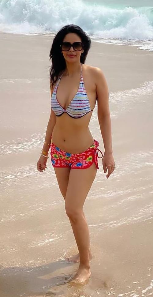mallika - Mallika Sherawat, 44, sizzles in a bikini - see her flaunt her sexy body on the beach.