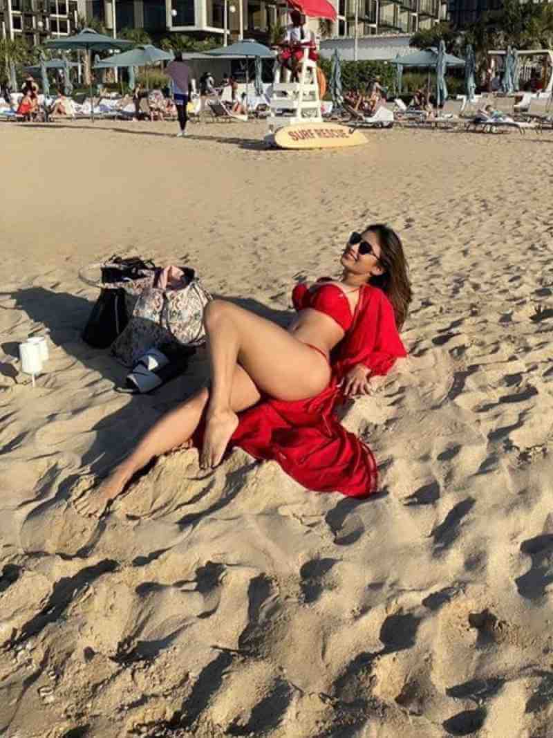 sexy mouni roy lying on beach in red bikini showing her sexy butts and long legs - Mouni Roy Bikini Photos | Hot Mouni Roy Bikini Swimsuit Pics Shows Off Her Toned Body